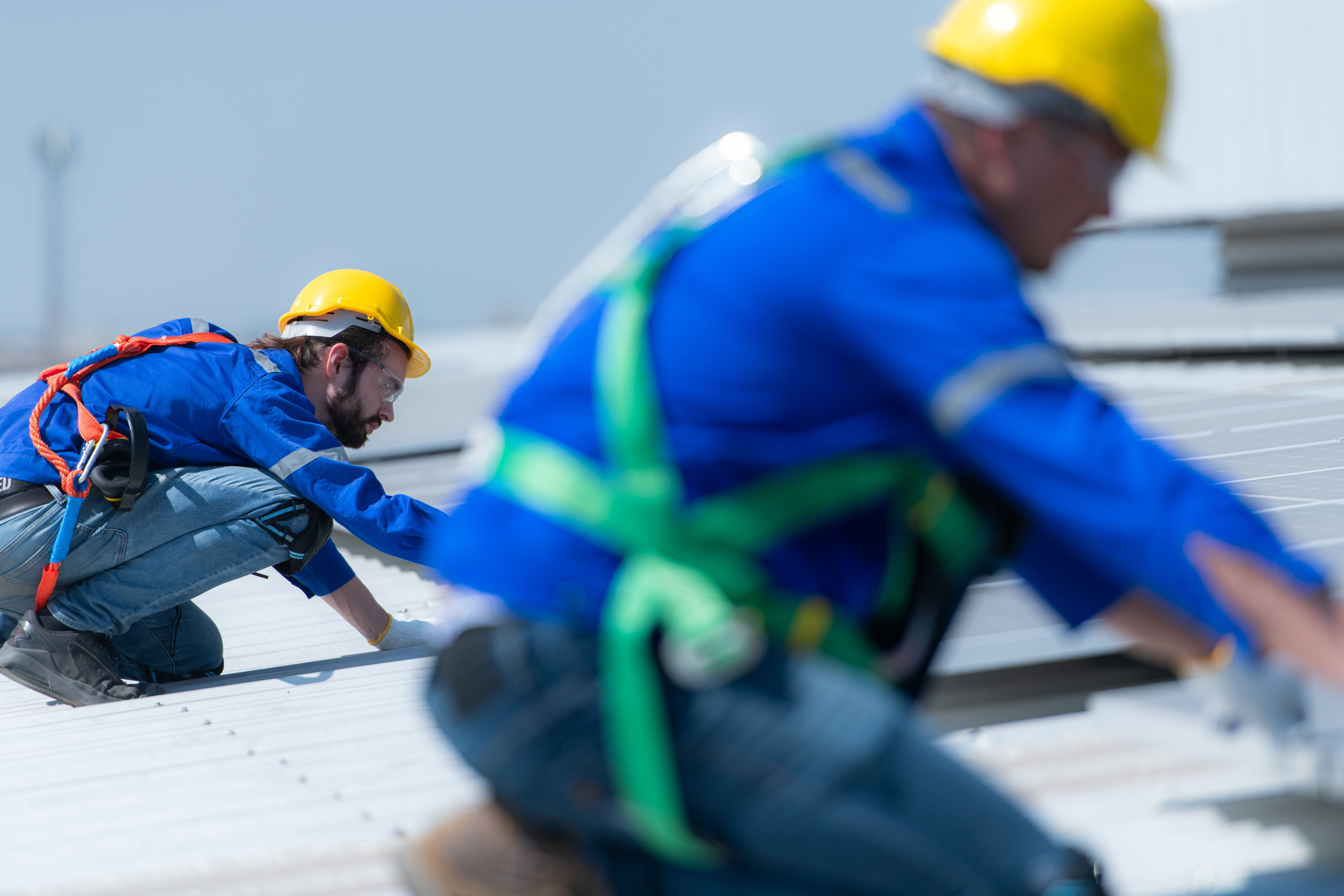 Technicians collaborating on a roof install